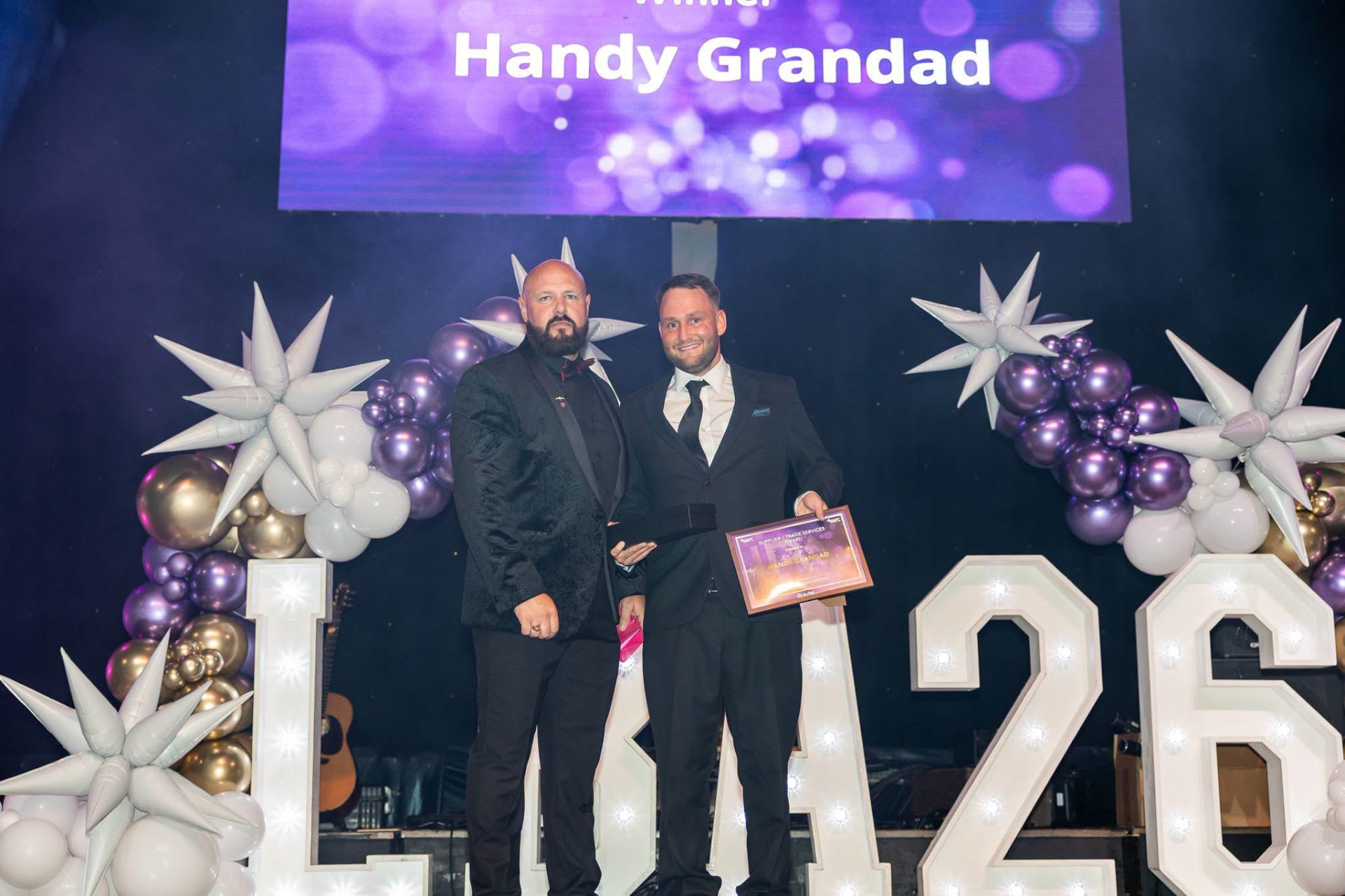 Handy Grandad collecting the Supplier and Trade Services Award on stage at the Coastal Local Business Awards 2026